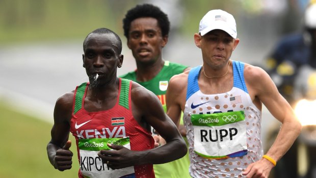 Feyisa Lilesa, centre, racing eventual winner Eliud Kipchoge of Kenya and bronze medallist Galen Rupp of the United States.