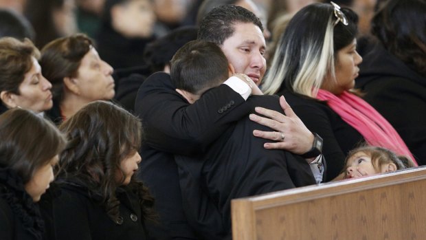 Ruben Porras and his family attend the funeral of Petra Ruiz Porras.
