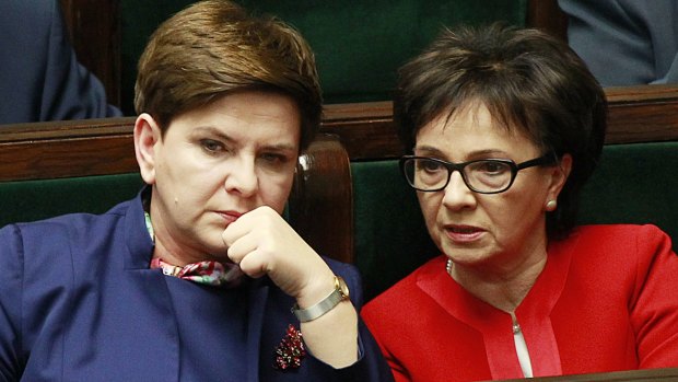 Polish Prime Minister Beata Szydlo,left, listens to a debate in the Parliament next to prominent member of the ruling Law and Justice party, and lawmaker  Elzbieta Witek, right, in Warsaw on Wednesday.