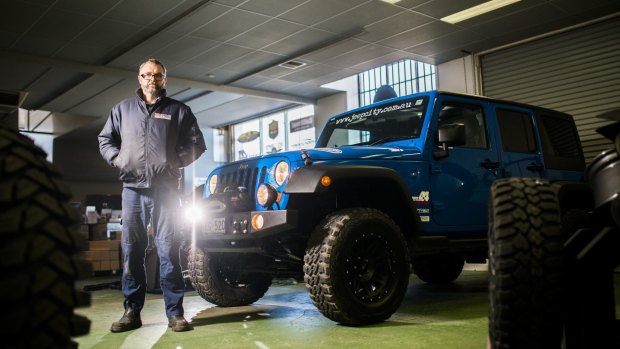 Jeep City owner Brett Quodling with a modified Jeep at his shop in Fyshwick. 

