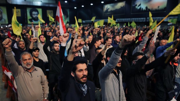 Supporters cheer as they listen to a speech by Hezbollah leader Sayyed Hassan Nasrallah, in Beirut, Lebanon, on Tuesday. Nasrallah said Turkey and Saudi Arabia are using Islamic State as a "pretext" to launch a ground operation in Syria.