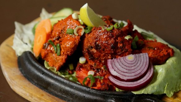 Sizzling chicken tikka kebab.