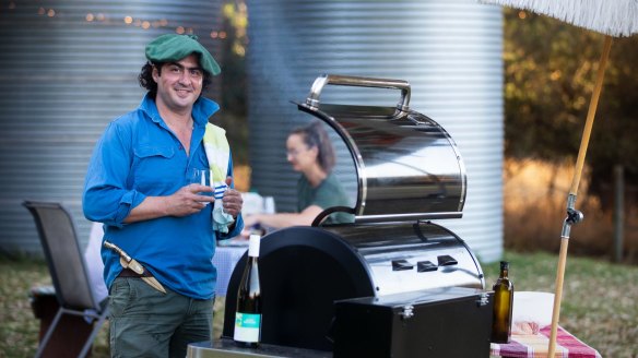 Lloyd Brothers winemaker Gonzalo Sanchez cooking a barbecue with a white wine spritzer in hand to keep cool.