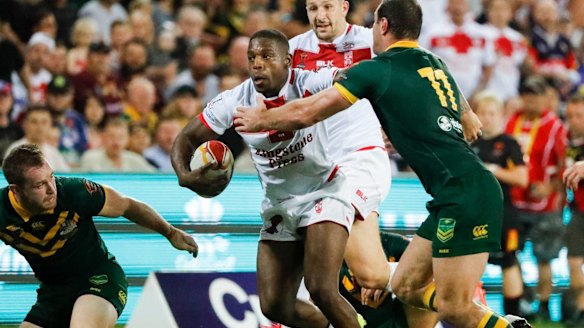 Fend: Kallum Watkins pushes off the Australian defence.