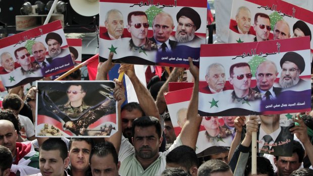 Syrians living in Lebanon hold posters with photos of Syrian President Bashar al-Assad, Russian President Vladimir Putin, Hezbollah leader Sheikh Hassan Nasrallah, and Lebanese Parliament Speaker Nabih Berri. The pro-government rally in front of the Russian embassy in Beirut on Sunday was to thank Russia for its military support.