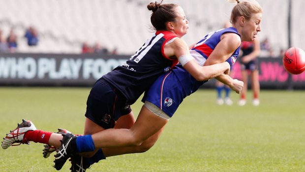 The Demons' Daisy Pearce tackles Katie Loynes, of the Bulldogs, during a women's exhibition match at the MCG.