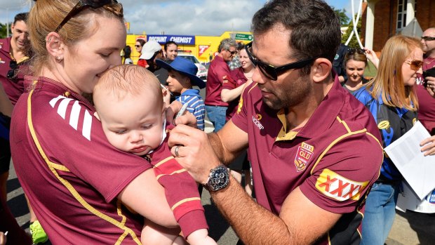 Cameron Smith signs autographs at a Maroons fan day on Tuesday.