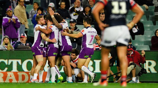 No mercy rule: Storm players celebrate another try in the 46-0 belting of the Roosters.