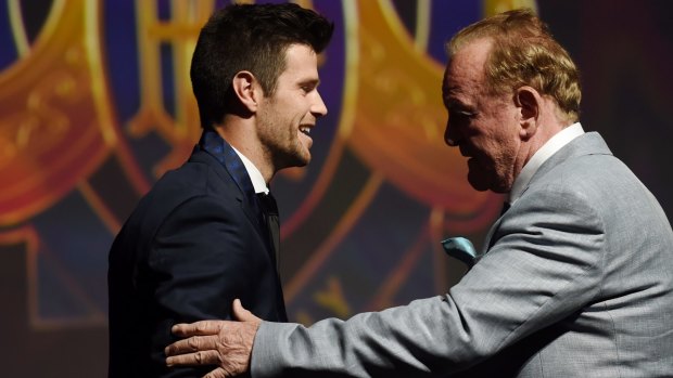 Richmond captain Trent Cotchin receives his Brownlow Medal from Ian Stewart.