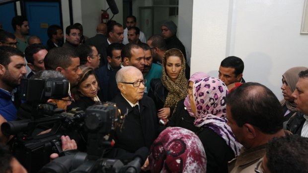 Tunisia's President Beji Caid Essebsi, centre, meets the family members of the presidential guard wounded in the terrorist attack that killed 12 others. 
