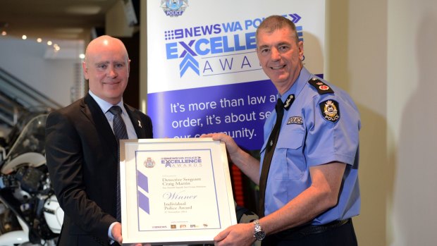 Detective-Sergeant Craig Martin with Police Commissioner Karl O'Callaghan.