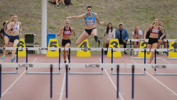 Canberra's Lauren Wells wins the 400 metre hurdles convincingly. Photo: Sitthixay Ditthavong