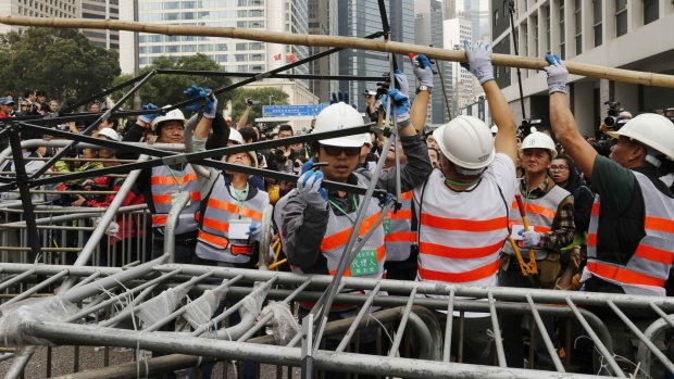 Workers dismantle the barricades in Hong Kong's Central district.