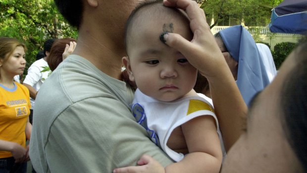 A nun places the sign of the cross sign on on a child's head in Manila, the Philippines. 