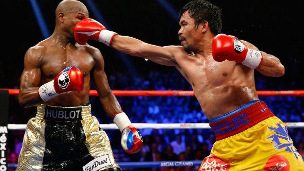 Manny Pacquiao throws a right at Floyd Mayweather during their welterweight unification championship bout in May 2015.