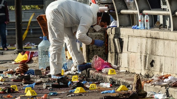 Forensic police inspect the blast site.