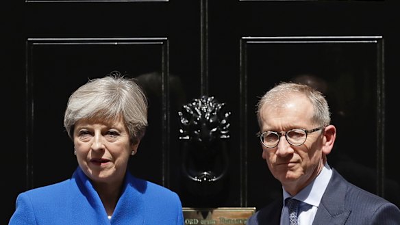 British Prime Minister Theresa May and her husband Philip stand on the doorstep of 10 Downing Street, London, after addressing the press on Friday.