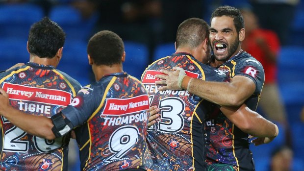 Victory: Greg Inglis of the Indigenous All Stars celebrates a try during the pre-season match between the Indigenous All Stars and the NRL All Stars.  