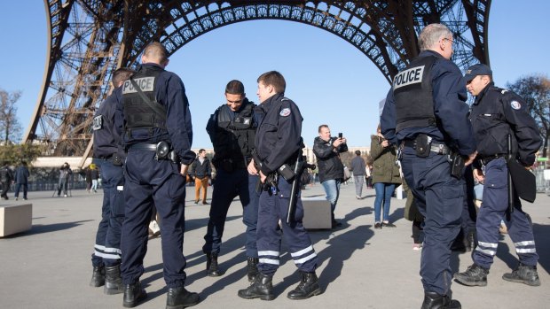 Police guard the Eiffel Tower.