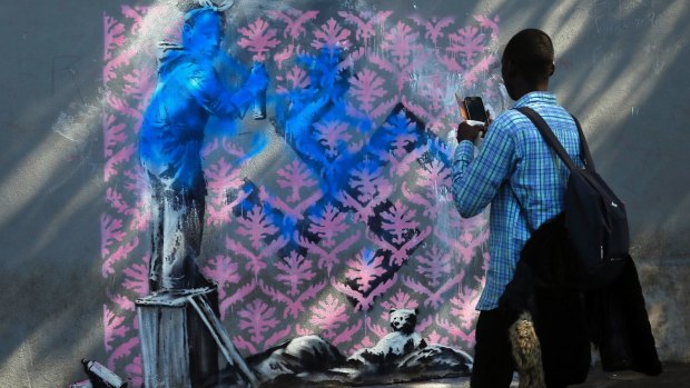 This work on a street in northern Paris where migrants often sleep rough, shows a black girl spray-painting pink wallpaper over a swastika. The painting has since been defaced to make it look like she is drawing the swastika herself.