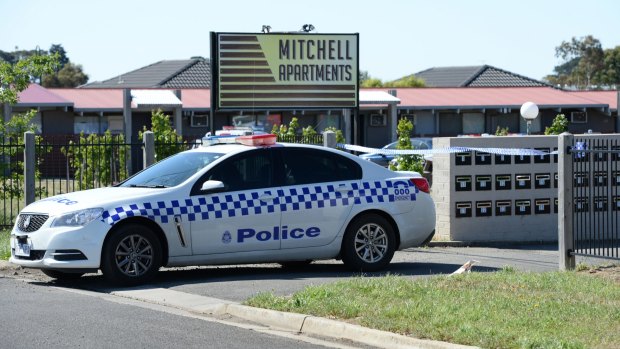 Police outside the Mitchell Apartments on Sunday.