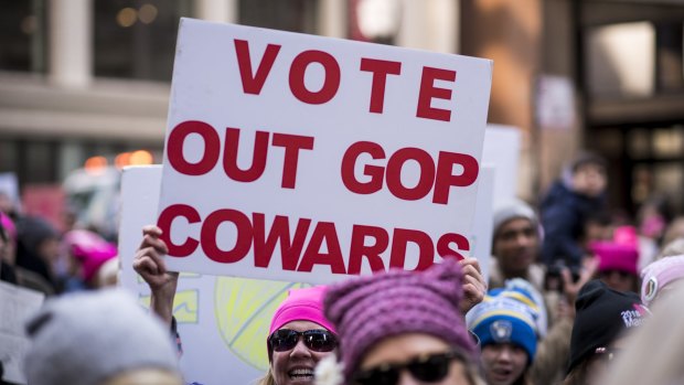 A demonstrator holds a sign that reads "Vote Out GOP Cowards" during the second annual Women's March in Chicago.