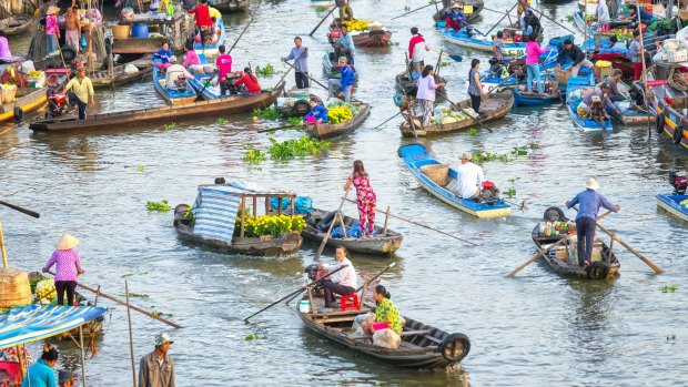 Bustling crowded living on floating market in Soc Trang, Vietnam.
