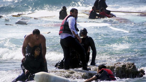 Migrants, who are trying to reach Greece, are rescued by members of the Greek Coast guard and locals near the coast of the southeastern island of Rhodes on  April 20. 