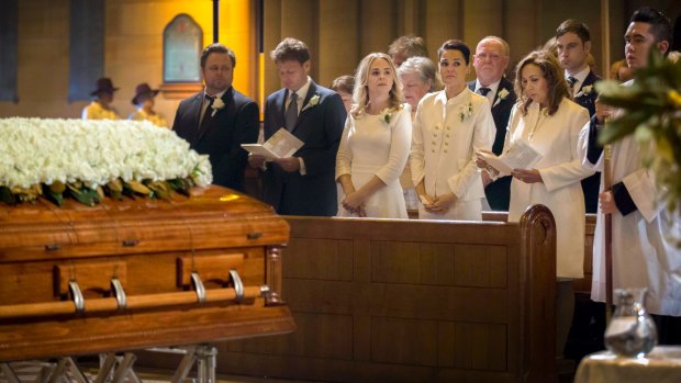 The family of veteran soccer broadcaster Les Murray attend his state funeral.