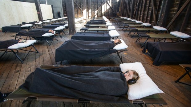 Audience members slow down to experience Marina Abramovic's Beds.
