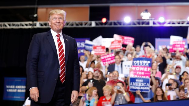 President Donald Trump stands before speaking at a rally at the Phoenix Convention Centre.