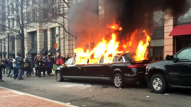 Protesters set a parked limousine on fire in downtown Washington on January 20, Inauguration Day. Scores were arrested for trashing property and attacking officers. 