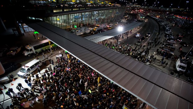 Demonstrators gather outside John F. Kennedy International Airport to protest against US President Donald Trump's executive order.