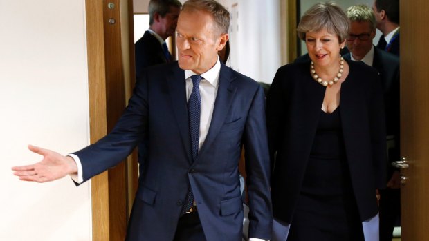 Donald Tusk, left, leading British Prime Minister Theresa May  to a meeting on the sidelines of the EU summit in Brussels. Tusk is dreaming that Brexit will never happen.