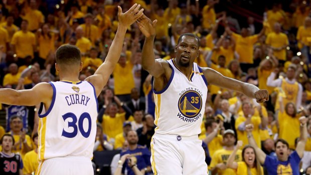 Golden boys: Steph Curry and Kevin Durant shone as the Warriors went 2-0 up in the series.