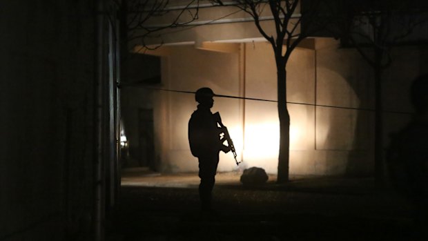 A member of the Afghan security forces at the site of a suicide attack targeting parliamentarian Gul Pacha Mujedi in Kabul on Sunday.