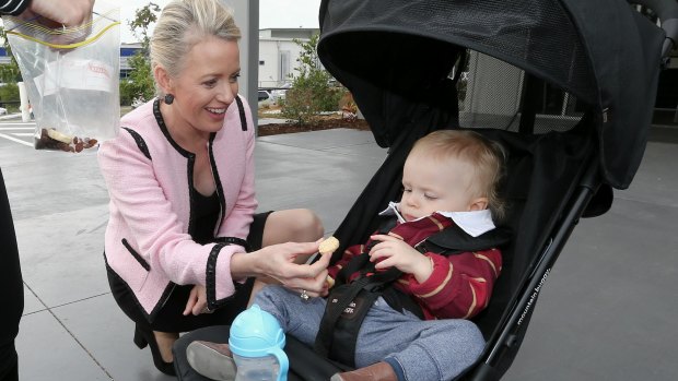 Chloe Shorten meets 15-month-old Maroons supporter Ethan Ricketts with out campaigning in Brisbane. 