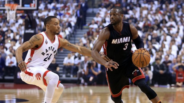 Veteran savvy: Heat guard Dwyane Wade dribbles the ball as Raptors forward Norman Powell defends in the first half of Miami's win in Toronto.