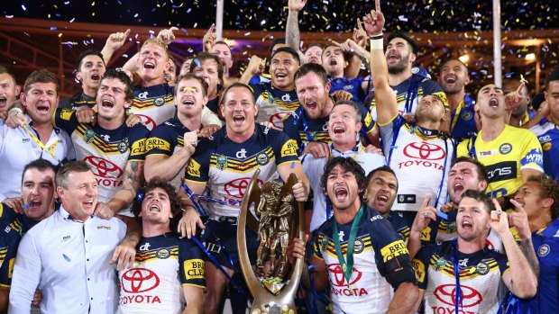 Title to defend: The Cowboys celebrate on the podium with the premiership trophy after winning the 2015 NRL Grand Final match over the Brisbane Broncos. Will North Queensland win again in 2016?