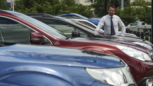 Hail on Saturday night caused damage to about 30 vehicles at the Capital Subaru dealership in Fyshwick. Dealer principal, Adam Clearihan, with some of the cars.
