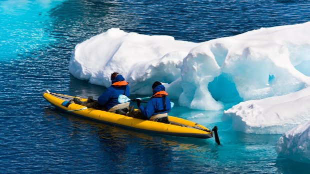 Canoe among icebergs in Antarctica.