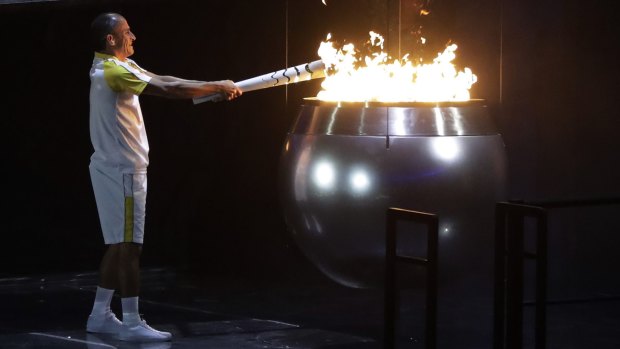 Vanderlei de Lima lights the Olympic flame during the opening ceremony.