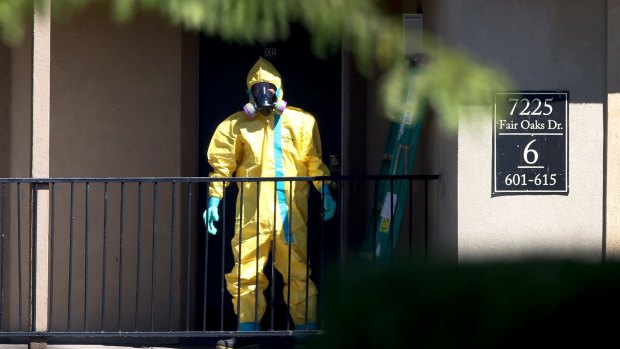 A hazmat team member arrives to clean a unit at the Ivy Apartments in Dallas, Texas, where the first confirmed Ebola virus patient in the US was staying.