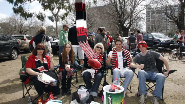 Saints fans enjoy a boot barbecue in the carpark outside the MCG at the 2010 grand final.
