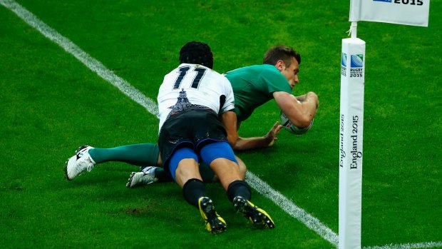 Tommy Bowe holds off Ionut Botezatu to score Ireland's fourth try at Wembley on Sunday.