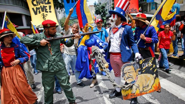 Government supporters perform a parody involving a Venezuelan militia member confronting Uncle Sam, symbolising the US government in Caracas on Monday.