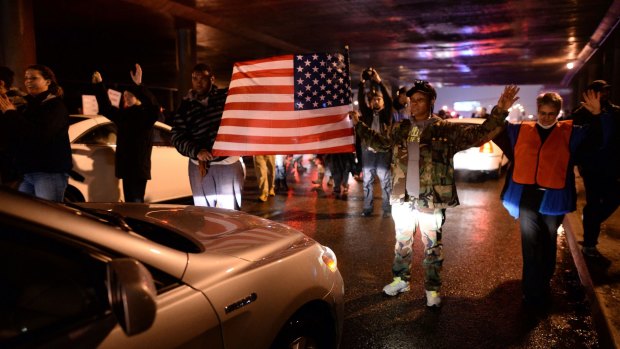 Demonstrators block an intersection during a march to protest the death of Michael Brown.