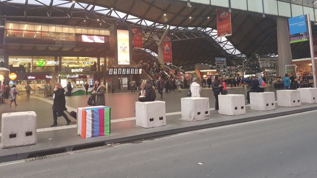 At Southern Cross Station, a temporary safety bollard is treated to some guerilla art.