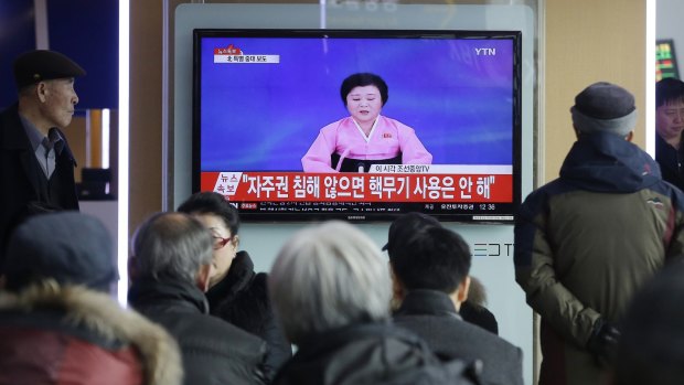 South Koreans at Seoul Railway Station watch a TV news program showing North Korea's announcement of its bomb test earlier this month.