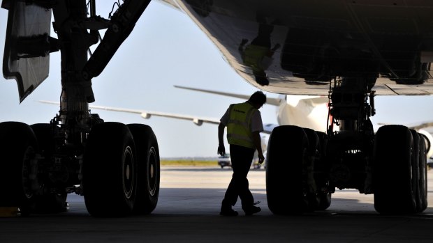 Undercarriage check: Flight engineer Kevin Reid does a "walk around" a Qantas A380 at Melbourne Airport.